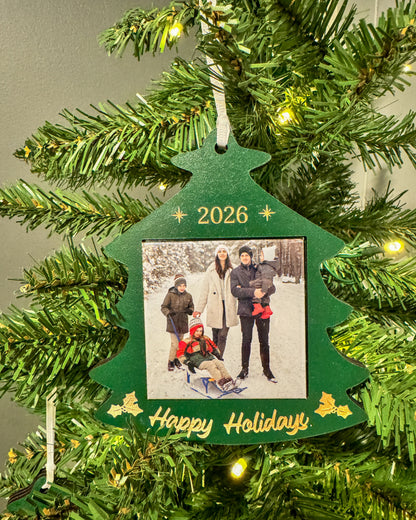 2026 green Christmas tree photo magnet ornament hanging on a lit Christmas tree