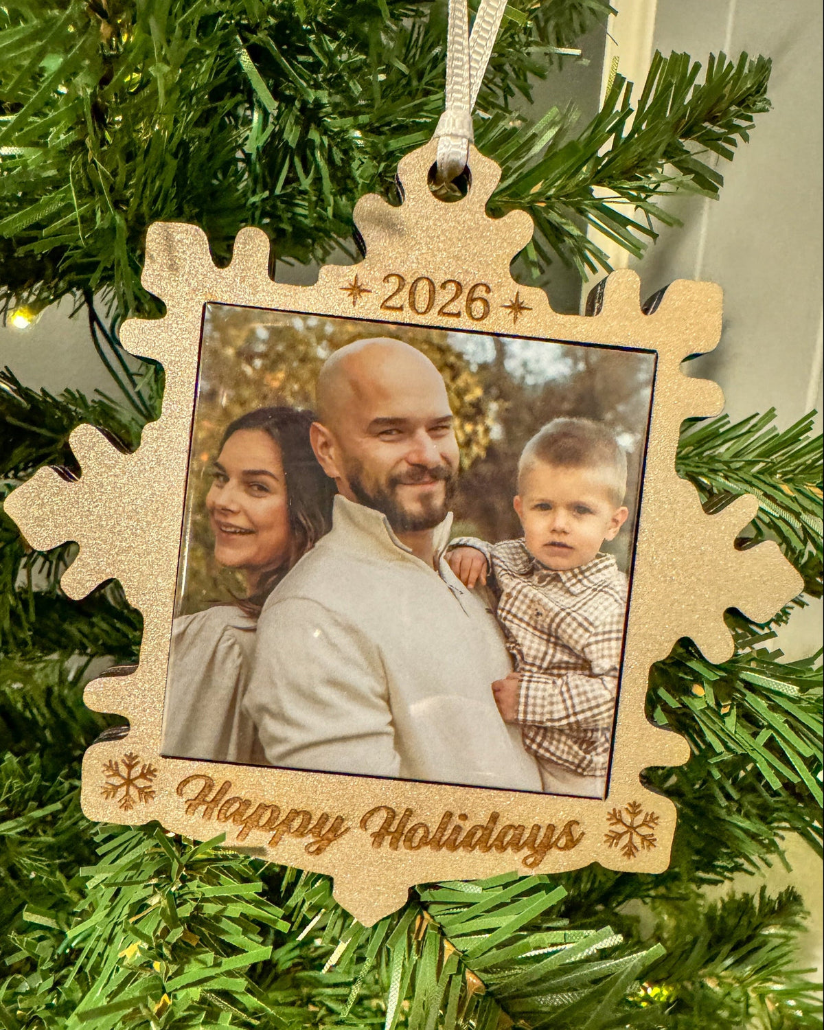2026 snowflake photo magnet ornament hanging on a Christmas tree
