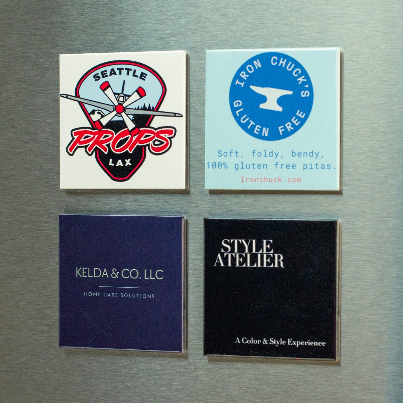 Grid of custom logo magnets from different businesses including sports teams, food brands, and service companies