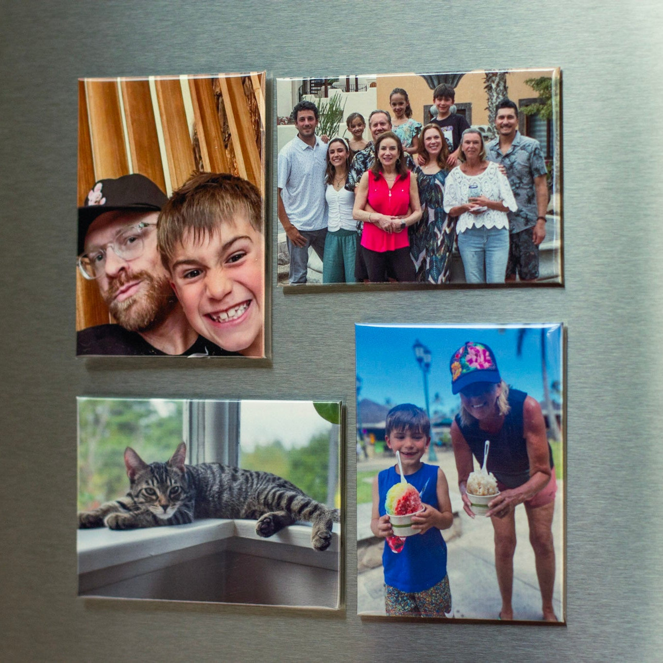 Custom photo magnets displayed on a refrigerator featuring family photos, a pet, and everyday moments