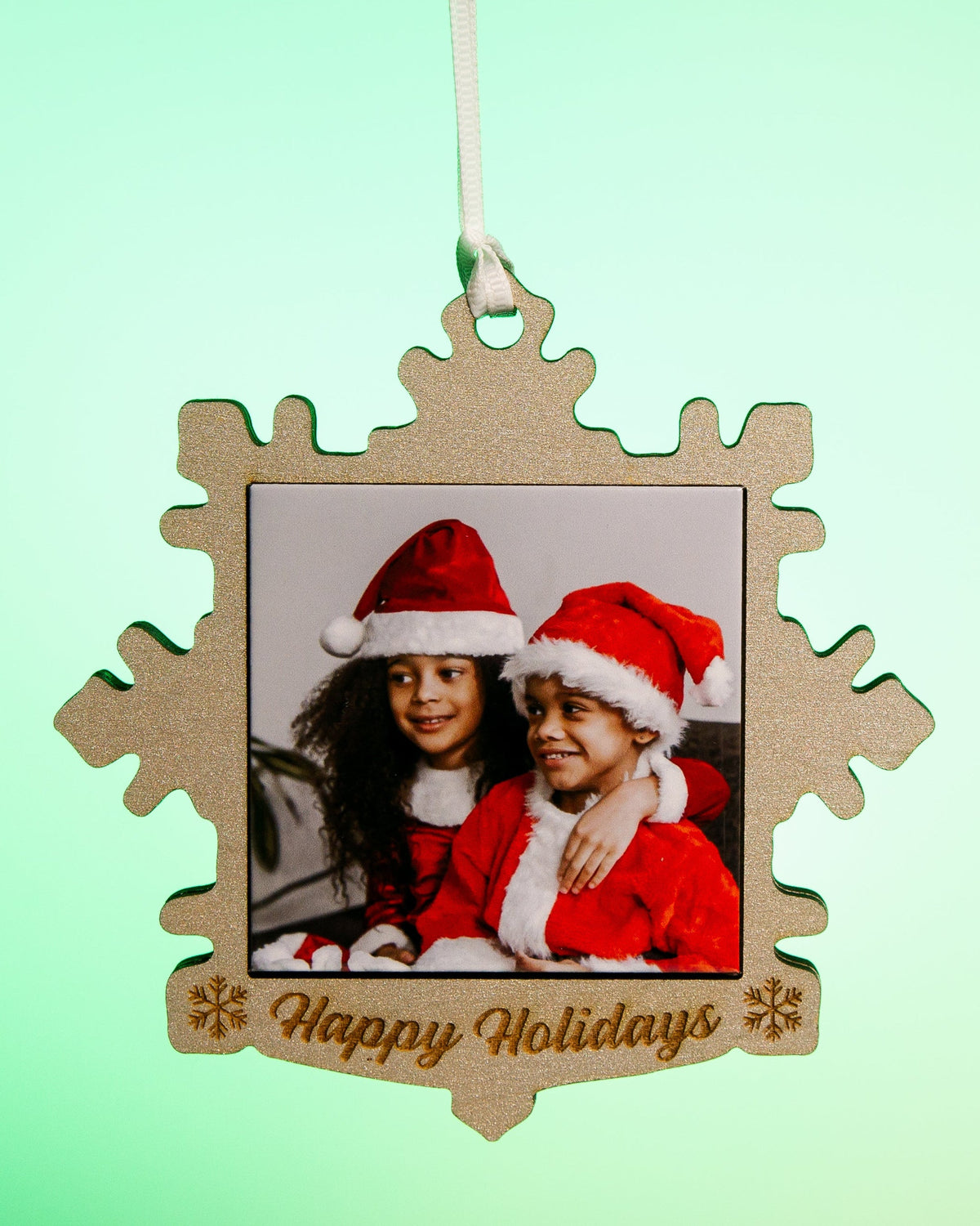 Silver snowflake photo magnet ornament with a custom holiday photo and Happy Holidays engraving