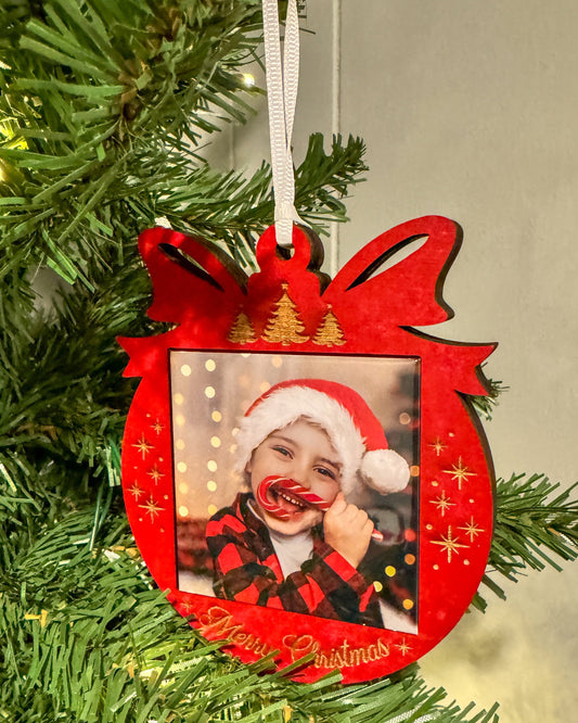 Red Merry Christmas photo magnet ornament hanging on a Christmas tree