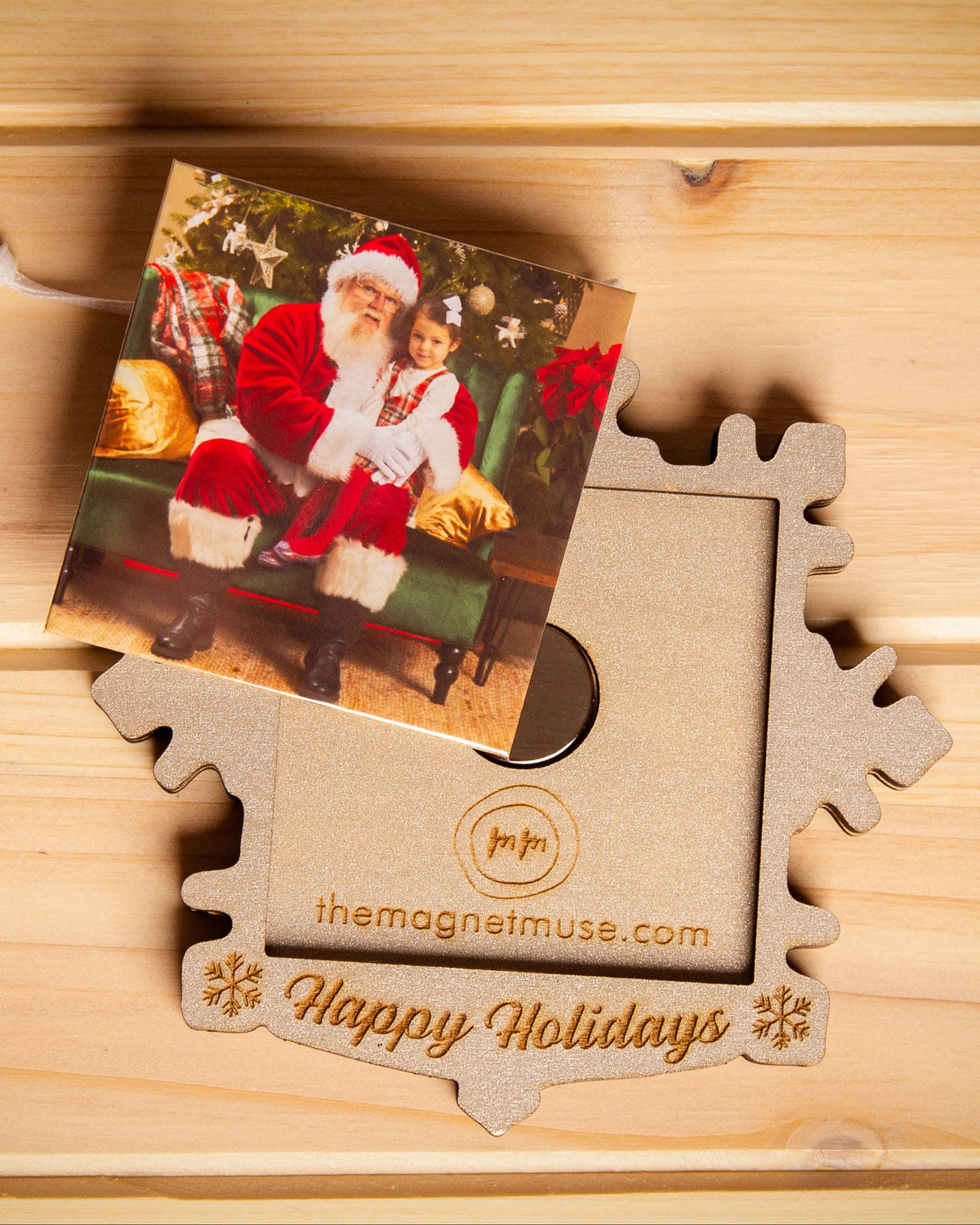 Removable custom photo magnet shown outside a silver snowflake holiday ornament
